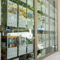 Spanish estate agency window displaying rental and property listings amid housing uncertainty