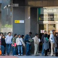 People queue outside a Spanish immigration office as demand rises for appointments under the new residency scheme