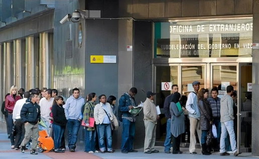 People queue outside a Spanish immigration office as demand rises for appointments under the new residency scheme