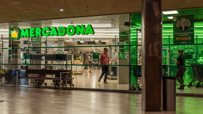 Mercadona supermarket entrance in Spain with store open and customers inside during shopping hours