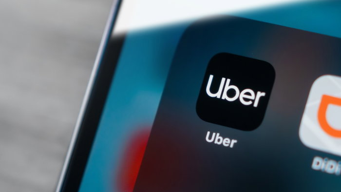 Uber app icon on smartphone screen as new hotel booking feature is introduced