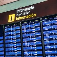 Airport departures board in Spain showing multiple routes as airlines cut weaker flights amid rising fuel costs