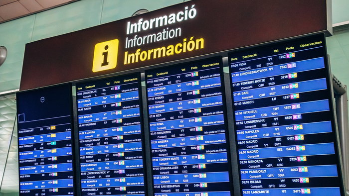 Airport departures board in Spain showing multiple routes as airlines cut weaker flights amid rising fuel costs