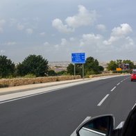 Car driving on a road in Malta with traffic signs and urban landscape