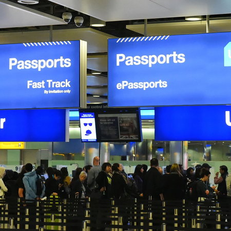 Passengers queue at UK border passport control amid new travel document checks