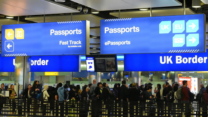 Passengers queue at UK border passport control amid new travel document checks