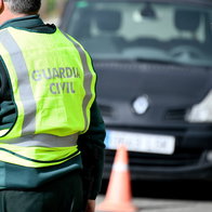 Guardia Civil traffic officer beside a car during a roadside speed control in Spain