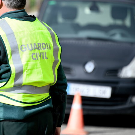 Guardia Civil traffic officer beside a car during a roadside speed control in Spain