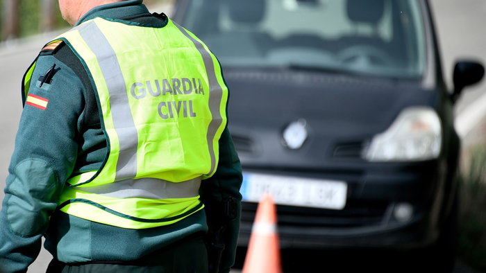 Guardia Civil traffic officer beside a car during a roadside speed control in Spain