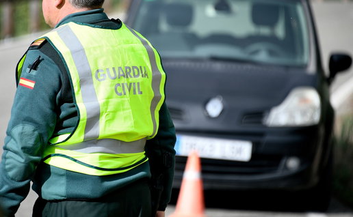 Guardia Civil traffic officer beside a car during a roadside speed control in Spain