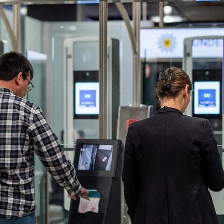Travellers using automated border control gates under the EU Entry Exit System at an airport