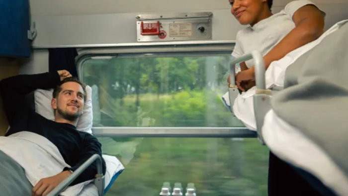 Passengers relaxing in a sleeper cabin on a night train