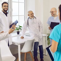 Group of healthcare professionals in a clinic discussing work in Spain
