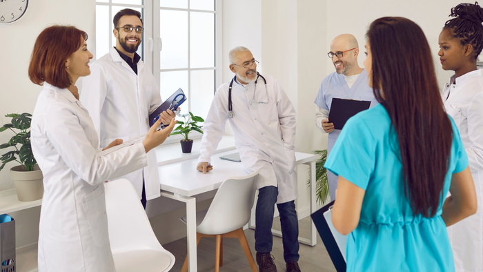 Group of healthcare professionals in a clinic discussing work in Spain