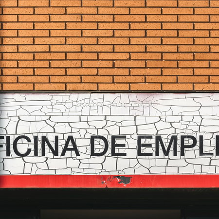 Spanish employment office sign on building facade