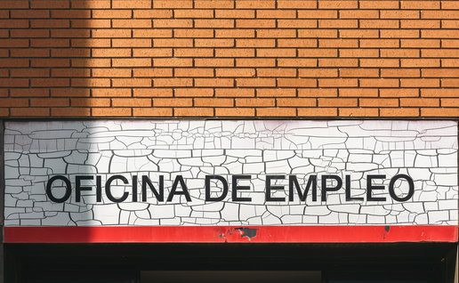 Spanish employment office sign on building facade