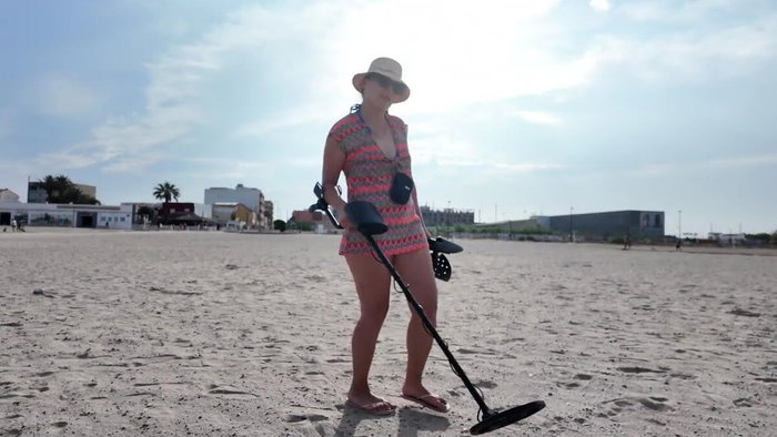 Woman filming a YouTube video on a Spanish beach