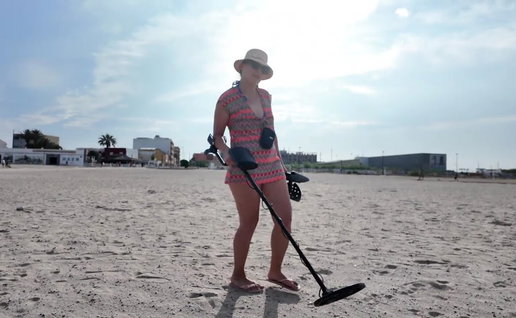 Woman filming a YouTube video on a Spanish beach