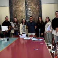 Group of young residents holding documents during housing allocation process in Alicante