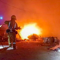 Firefighters extinguishing fire in rural agricultural building at night near Aigues Alicante
