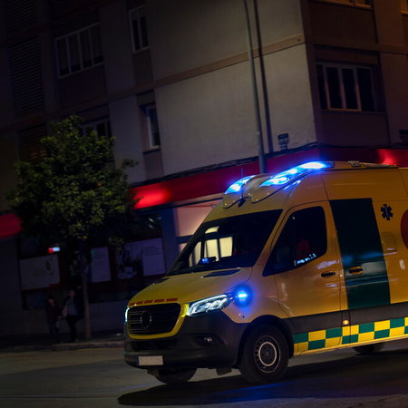 Ambulance attending an emergency scene at night in Spain