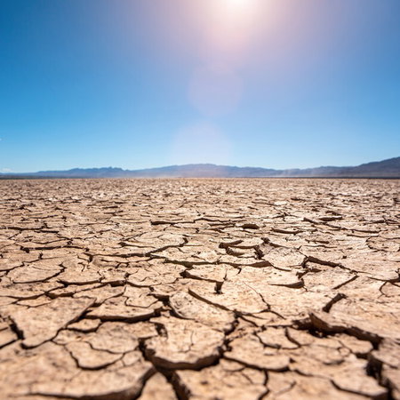 Cracked dry land under intense heat representing uninhabitable future climate on Earth