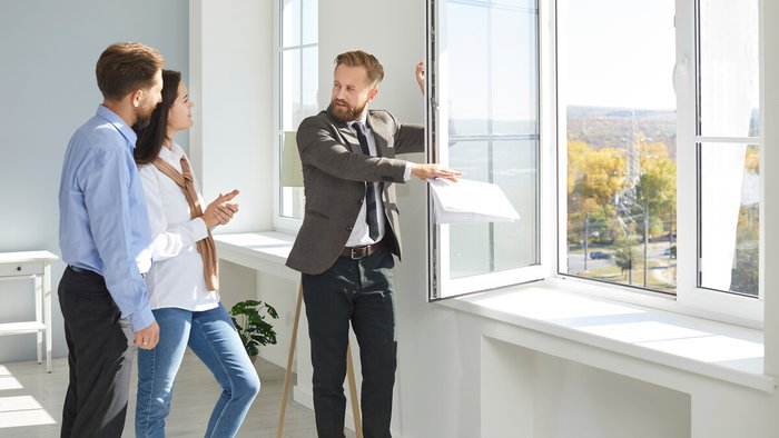 Couple viewing a property with real estate agent in Spain