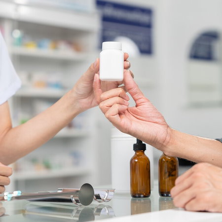 Person purchasing homeopathic remedies at a pharmacy counter in Spain