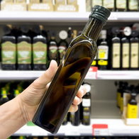 Bottles of olive oil on supermarket shelf in Spain