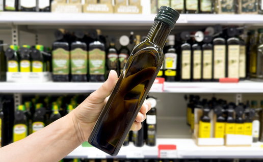 Bottles of olive oil on supermarket shelf in Spain
