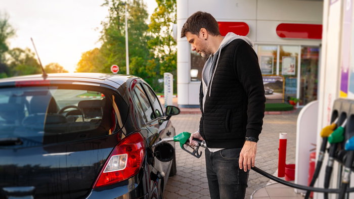 Person refuelling car at petrol station in Spain as fuel prices rise