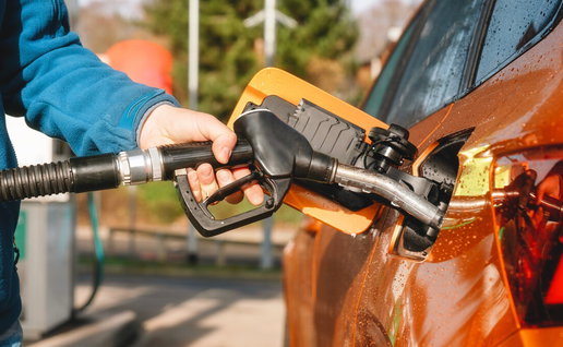 Driver refuelling car at a petrol station in Spain during normal operations after strike cancellation