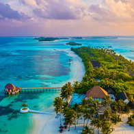 Aerial view of Maldives islands surrounded by turquoise water showing low-lying coastline