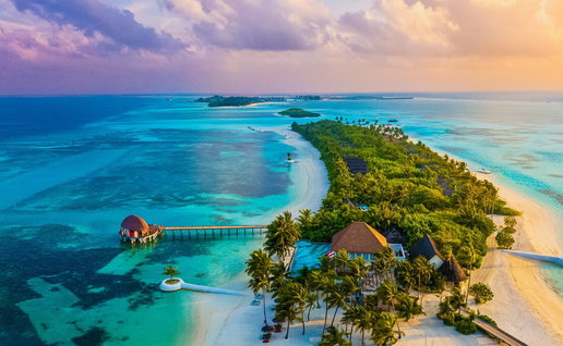 Aerial view of Maldives islands surrounded by turquoise water showing low-lying coastline