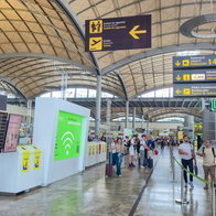 Passengers inside Alicante-Elche Miguel Hernández Airport terminal during busy travel period