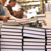Visitors browsing book stalls at Elche book fair along Paseo de la Estación
