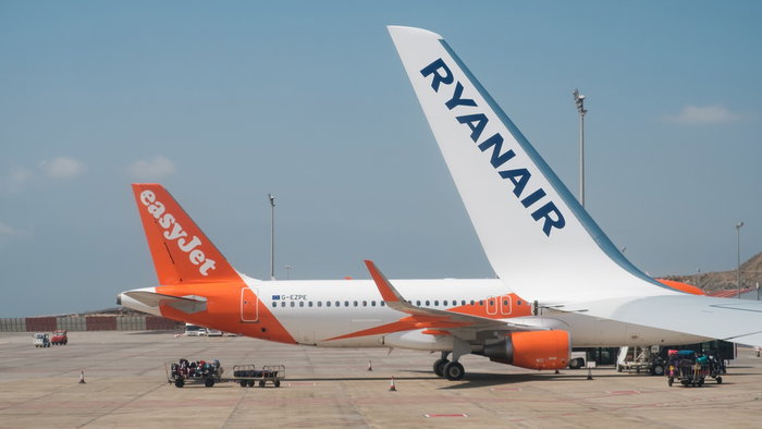 Ryanair and easyJet planes parked on an airport tarmac with visible airline branding