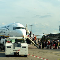 Passengers boarding a Ryanair aircraft on the tarmac during summer travel season