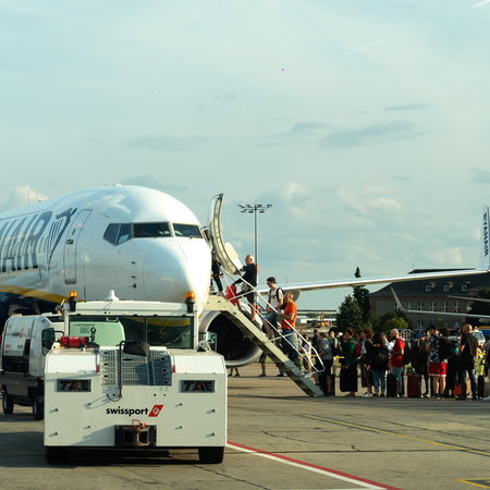 Passengers boarding a Ryanair aircraft on the tarmac during summer travel season
