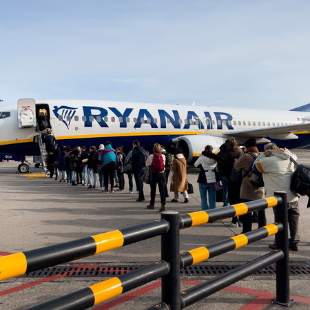 Passengers boarding a Ryanair plane on the tarmac as concerns grow over flights and rising ticket prices