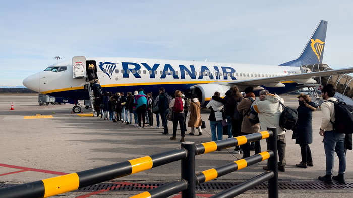 Passengers boarding a Ryanair plane on the tarmac as concerns grow over flights and rising ticket prices