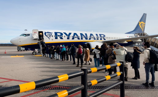 Passengers boarding a Ryanair plane on the tarmac as concerns grow over flights and rising ticket prices