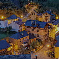 Aerial view of San Facundo, a small mountain village in León, Spain, with illuminated houses at dusk