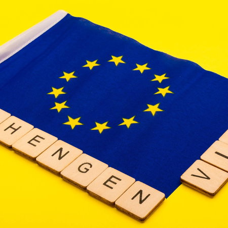 European Union flag with “Schengen visa” text representing travel rules in Europe