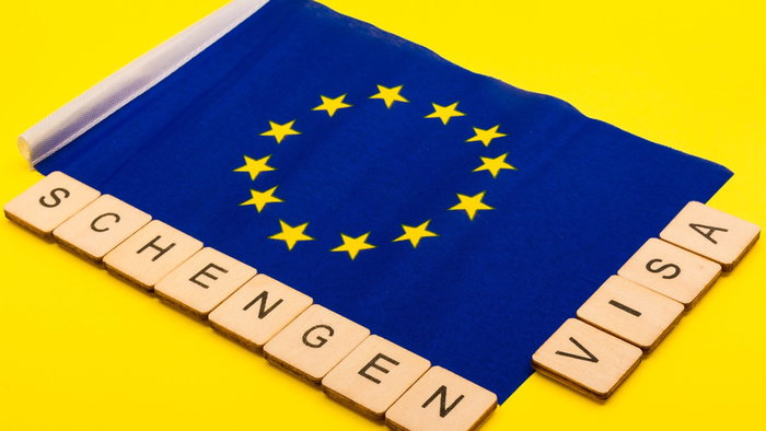 European Union flag with “Schengen visa” text representing travel rules in Europe