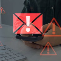 Person checking a mobile phone with warning symbols during a fake Social Security scam alert in Spain