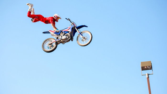 Freestyle motorcross motorcyclist caught in midair at festival in East Texas