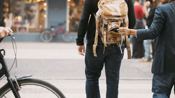 Pickpocket stealing walled from bag