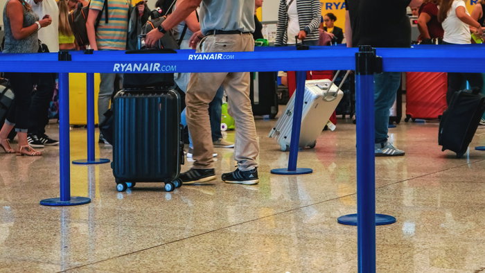 Passengers queuing at a Ryanair check-in