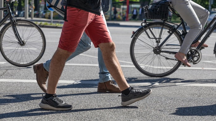 Walking and cycling across a pedestrian road